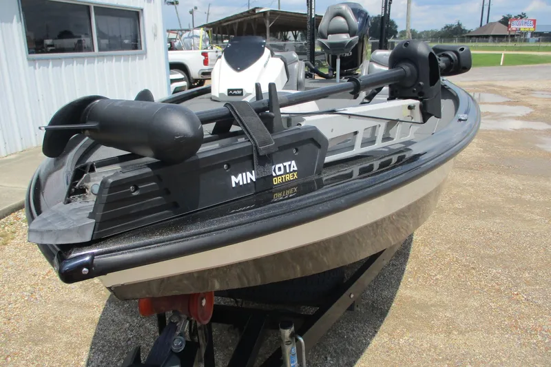 Slide: The Image of 2021 Avid 20XB boat with Minn Kota Ultrex trolling motor, parked outdoors. - 3