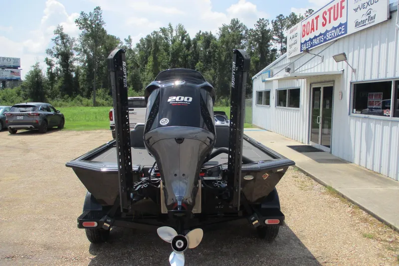 Slide: The Image of 2021 Avid 20XB boat with 200 horsepower engine outside dealership. - 4