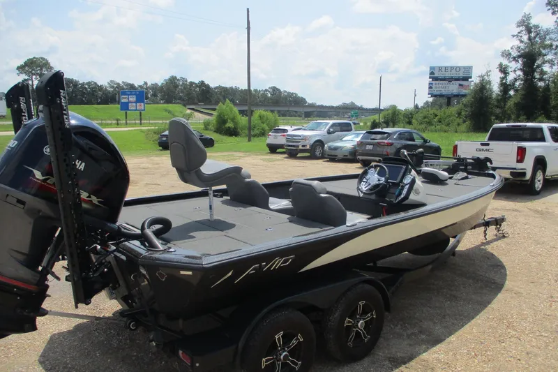Slide: The Image of 2021 Avid 20XB boat on trailer in parking lot, featuring Yamaha engine. - 5