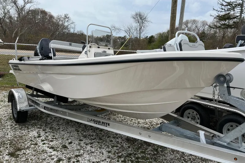 The Image of 2026 Carolina Skiff 21 LS boat on trailer, parked outdoors. - 1