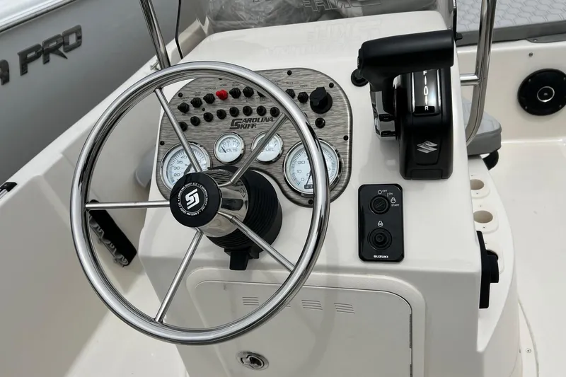 Slide: The Image of Steering console of a 2026 Carolina Skiff 21 LS boat with gauges and controls. - 10