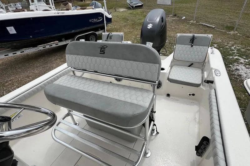 Slide: The Image of 2026 Carolina Skiff 21 LS boat interior with gray seating and steering wheel. - 11