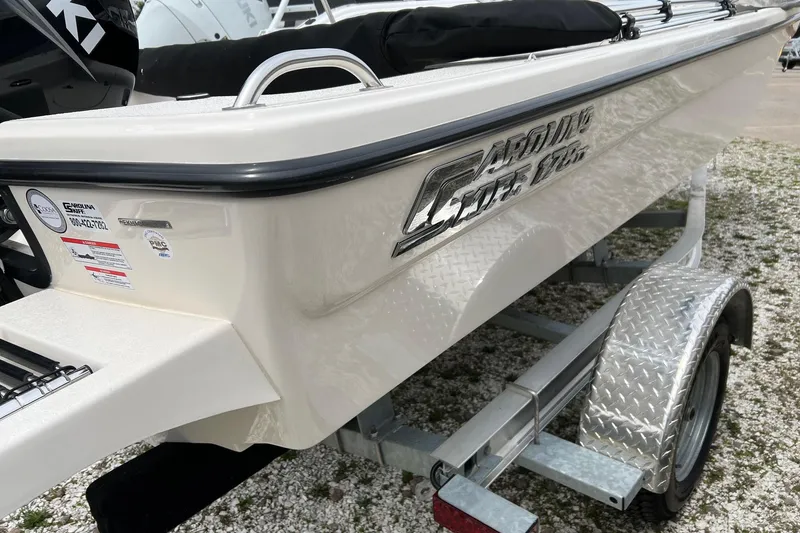 Slide: The Image of 2026 Carolina Skiff 21 LS boat on trailer, showcasing sleek design and branding. - 14