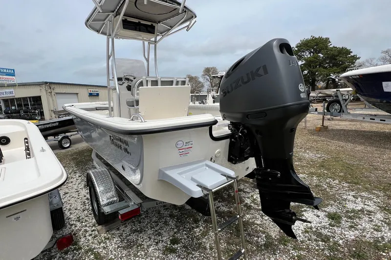 Slide: The Image of 2026 Carolina Skiff 21 LS boat with Suzuki outboard motor on display. - 16