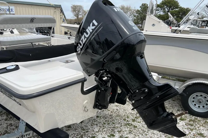 Slide: The Image of 2026 Carolina Skiff 21 LS with Suzuki outboard motor, parked on a trailer. - 30