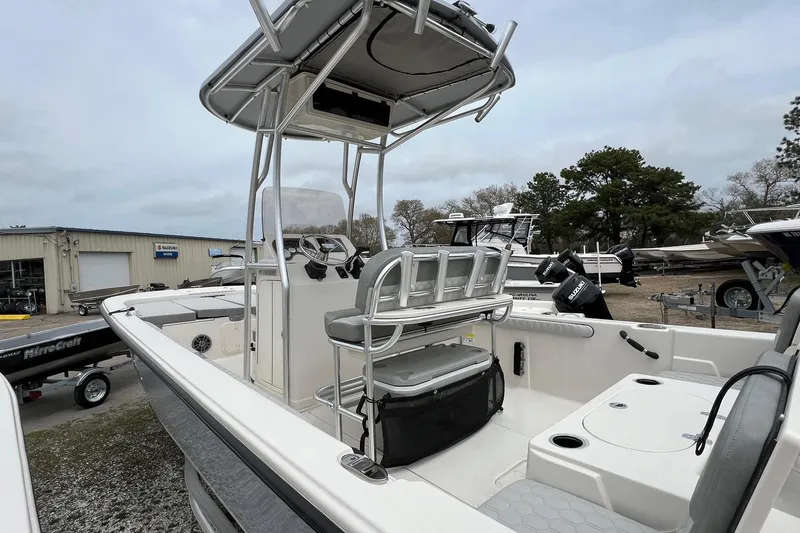 Slide: The Image of 2026 Carolina Skiff 21 LS boat with center console and seating, displayed outdoors. - 5