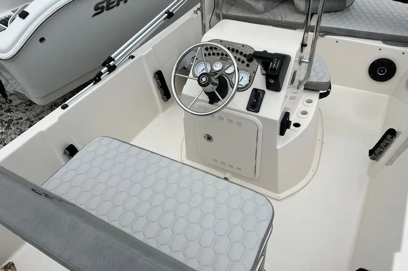Slide: The Image of 2026 Carolina Skiff 21 LS boat interior with steering console and seating. - 6