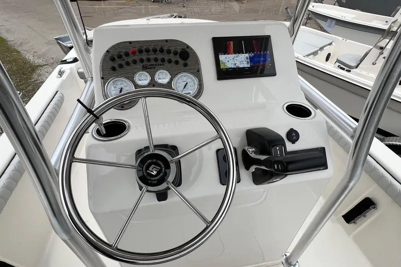 Slide: The Image of 2026 Carolina Skiff 21 LS boat dashboard with steering wheel and navigation display. - 9