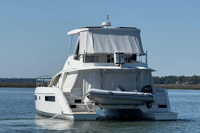 Slide: The Image of 2021 Leopard 43 Powercat yacht on water, rear view with dinghy attached. - 4