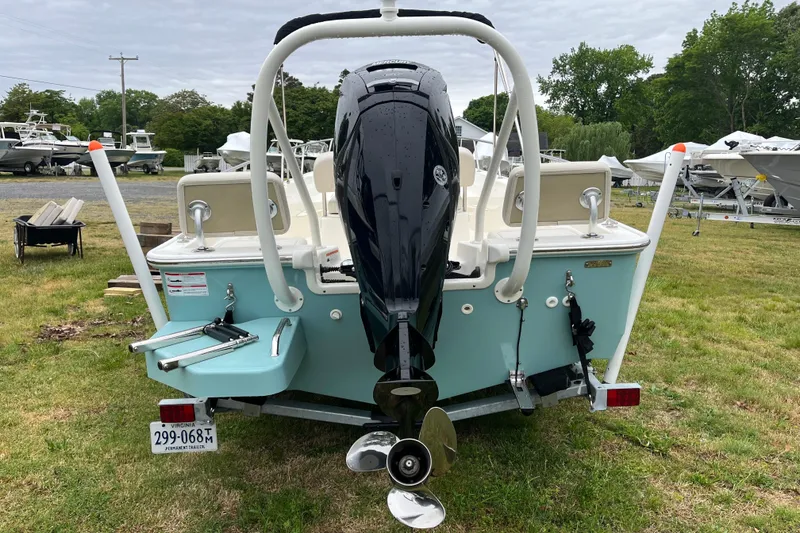 Slide: The Image of 2023 Boston Whaler 170 Montauk boat with outboard motor on grassy area. - 18