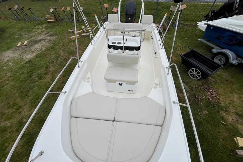 Slide: The Image of 2023 Boston Whaler 170 Montauk boat interior with seating and console, viewed from above. - 2