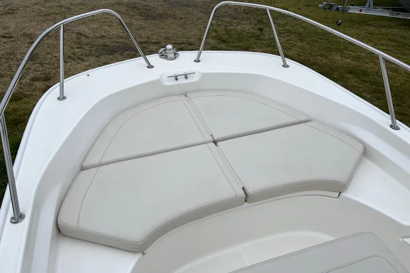 Slide: The Image of 2023 Boston Whaler 170 Montauk boat bow with cushioned seating and stainless steel railings. - 8