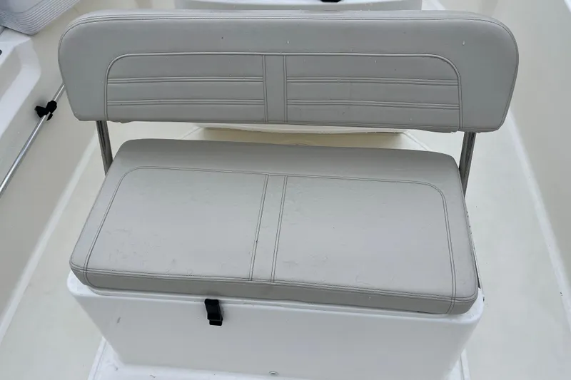 Slide: The Image of 2023 Boston Whaler 170 Montauk boat seat with cushioned backrest and storage compartment. - 9