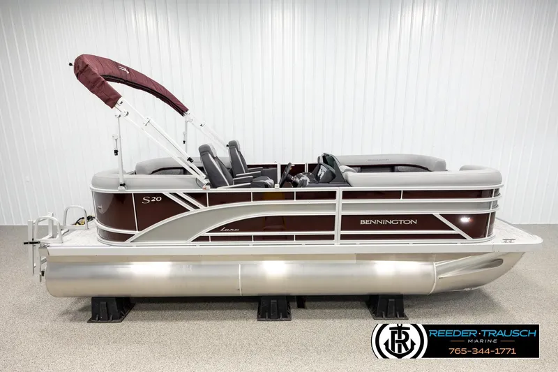 The Image of 2026 Bennington S20 Luxe pontoon boat with maroon and silver design in showroom. - 1