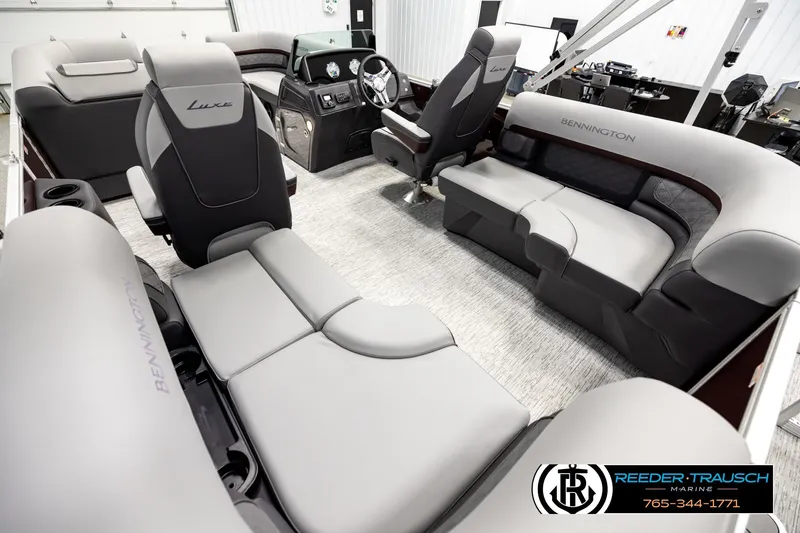 Slide: The Image of Luxurious interior of 2026 Bennington S20 Luxe pontoon boat with plush seating and modern dashboard. - 11