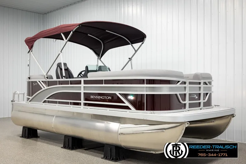Slide: The Image of 2026 Bennington S20 Luxe pontoon boat with maroon canopy in showroom. - 3