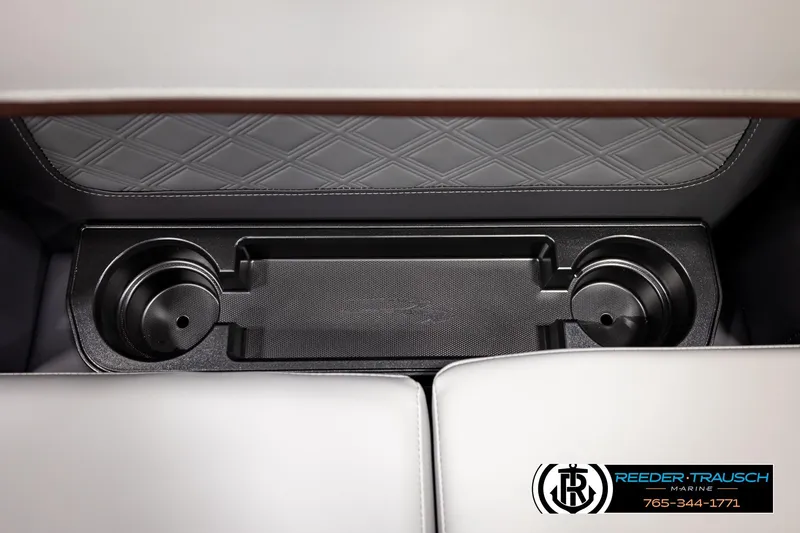 Slide: The Image of Interior of 2026 Bennington S20 Luxe with cup holders and diamond-stitched upholstery. - 41