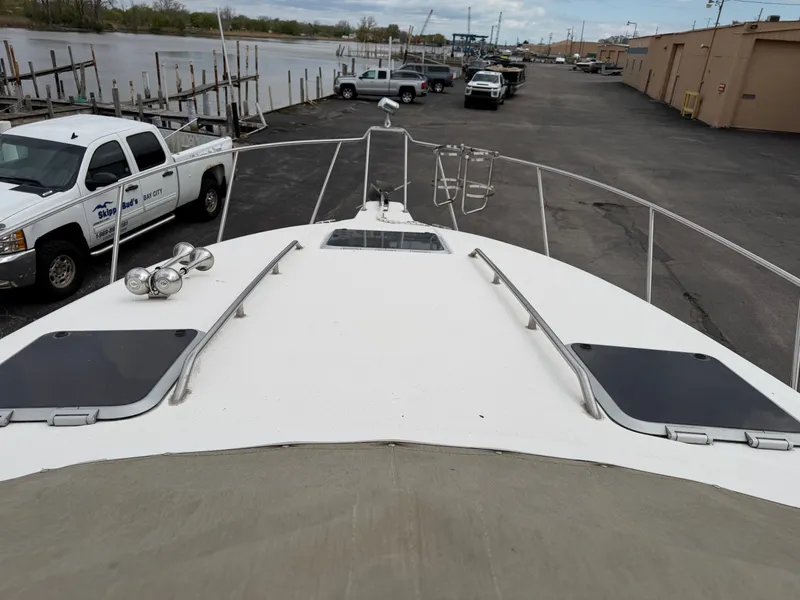Slide: The Image of 1990 Chaparral Signature 30 boat docked with vehicles in the background. - 23