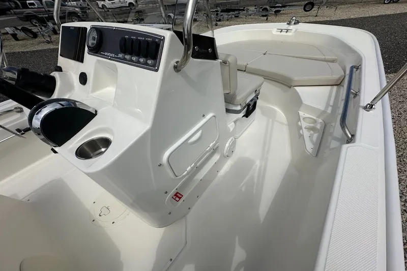 Slide: The Image of The image shows the cockpit of a 2027 Boston Whaler 170 Montauk with a helm console and seating area. - 13