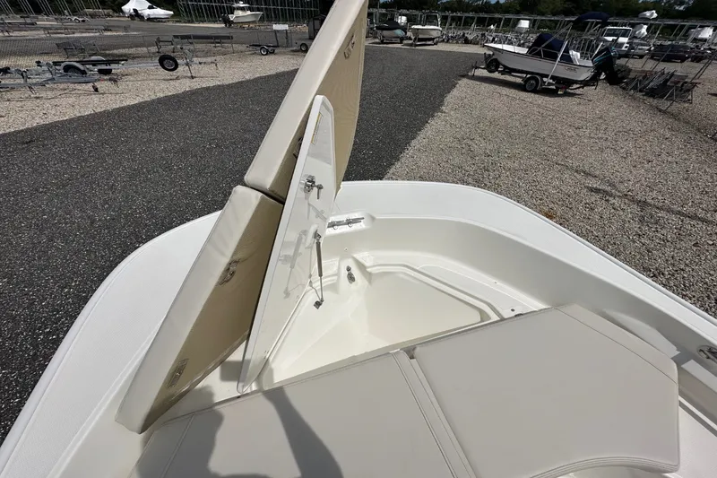 Slide: The Image of The image shows the bow of a Boston Whaler 170 Montauk with an open storage hatch. - 11