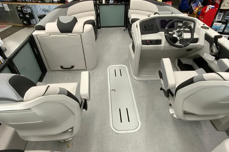 Slide: The Image of 2026 Avalon LSZ 2385 QL boat interior with modern seating and steering console. - 12