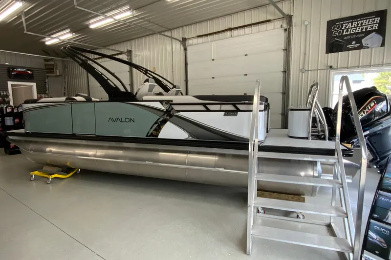 Slide: The Image of 2026 Avalon LSZ 2385 QL pontoon boat displayed in a showroom with modern design. - 22