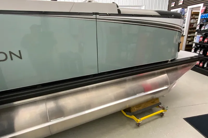 Slide: The Image of 2026 Avalon LSZ 2385 QL pontoon boat in showroom, side view. - 27