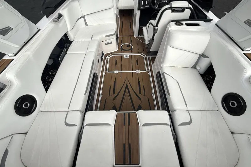 Slide: The Image of Luxurious interior of 2024 Supra SA 550 boat with white seating and wood accents. - 10