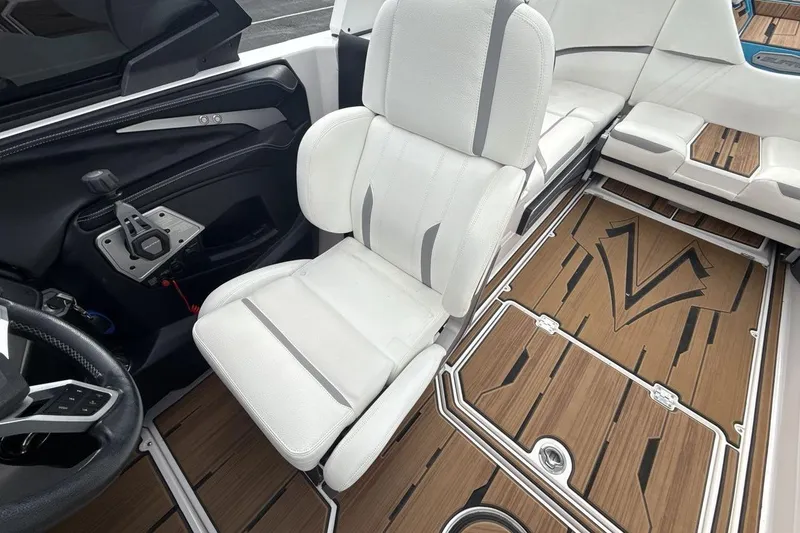 Slide: The Image of 2024 Supra SA 550 boat interior with white seating and stylish wood flooring. - 13