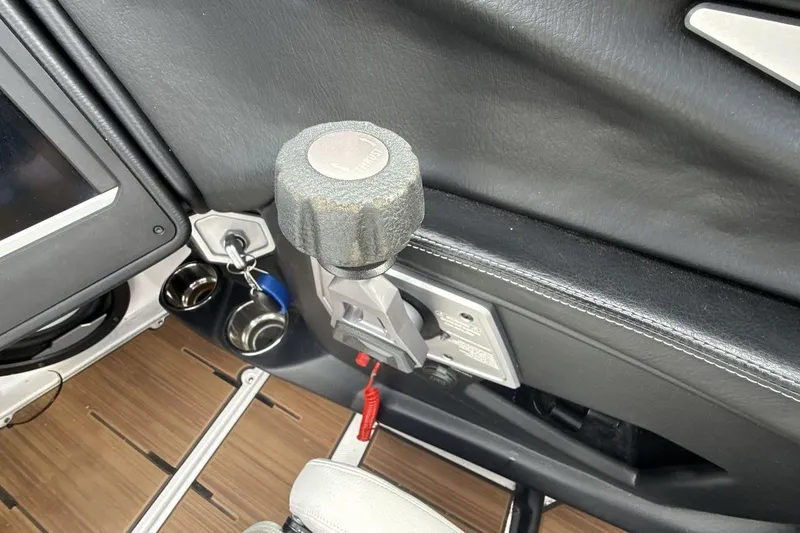 Slide: The Image of 2024 Supra SA 550 interior detail with control knob and cup holders. - 16