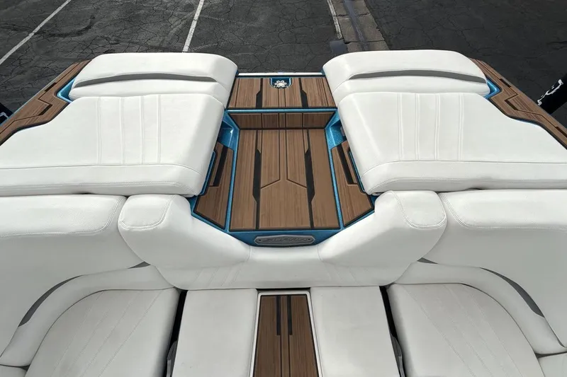 Slide: The Image of 2024 Supra SA 550 boat interior with white seating and wood accents. - 19
