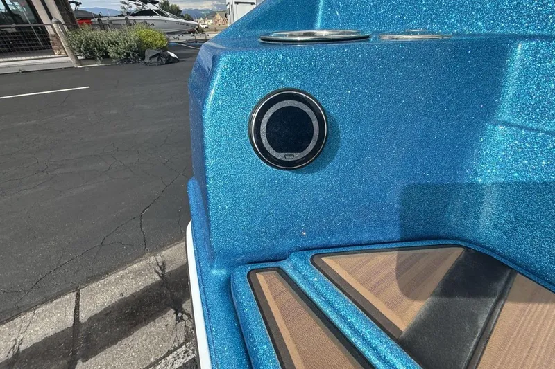 Slide: The Image of 2024 Supra SA 550 boat with blue metallic finish and speaker detail. - 27