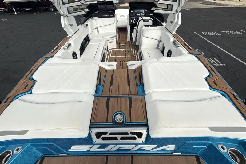 Slide: The Image of 2024 Supra SA 550 boat interior with luxurious white seating and sleek design. - 9