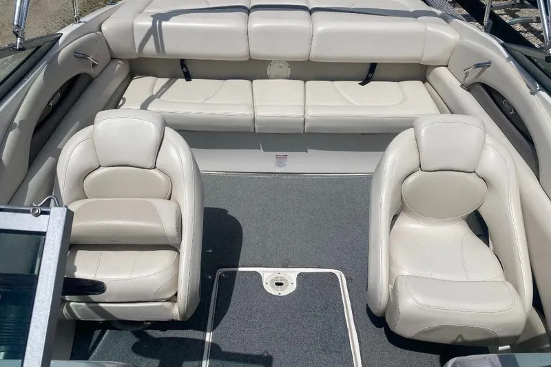 Slide: The Image of 2005 Chaparral 210 SSi boat interior with white leather seating and carpeted floor. - 5