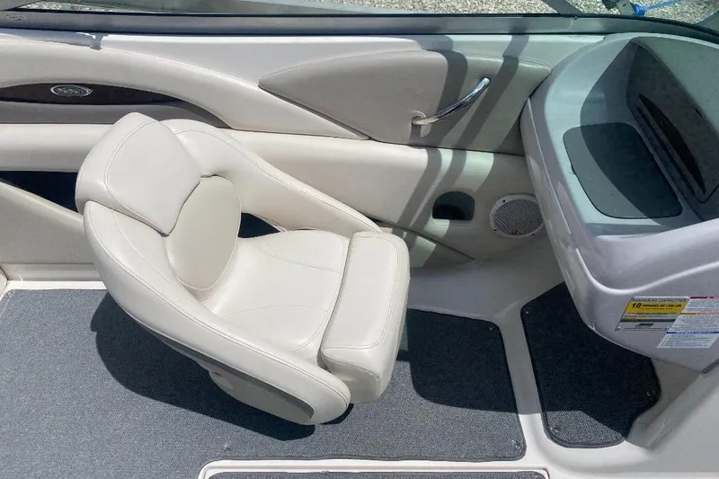 Slide: The Image of 2005 Chaparral 210 SSi boat interior with white leather seat and dashboard. - 6