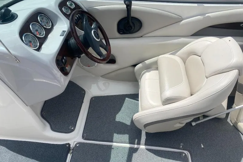 Slide: The Image of 2005 Chaparral 210 SSi boat interior with steering wheel and cushioned seat. - 7