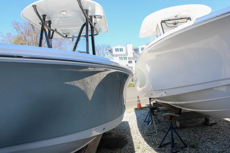 Slide: The Image of Two Sea Hunt Ultra 219 boats from 2026 on stands, side by side. - 10