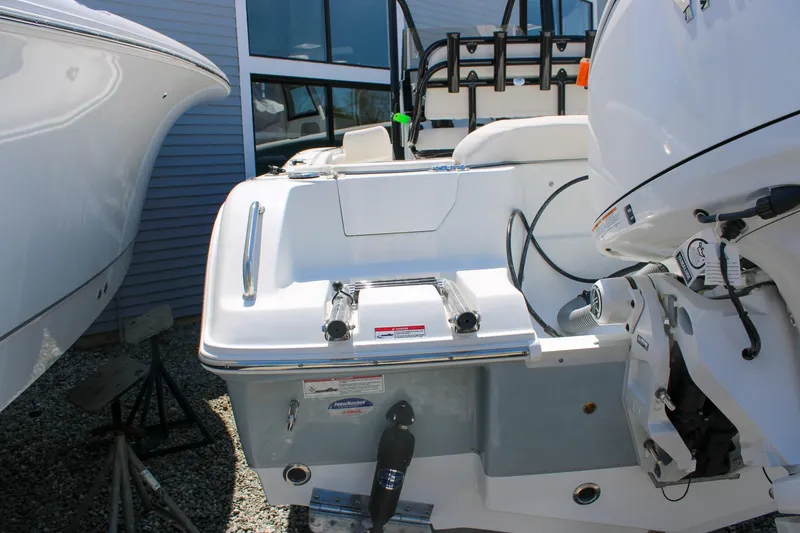 Slide: The Image of 2026 Sea Hunt Ultra 219 boat stern with motor and ladder. - 11