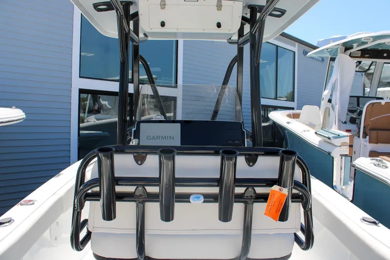 Slide: The Image of 2026 Sea Hunt Ultra 219 boat interior with Garmin equipment and rod holders. - 13