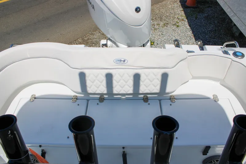 Slide: The Image of 2026 Sea Hunt Ultra 219 boat interior with white seating and rod holders. - 15
