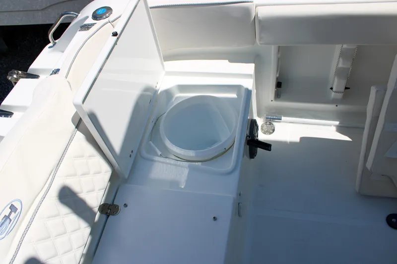 Slide: The Image of 2026 Sea Hunt Ultra 219 boat interior with open storage compartment. - 18