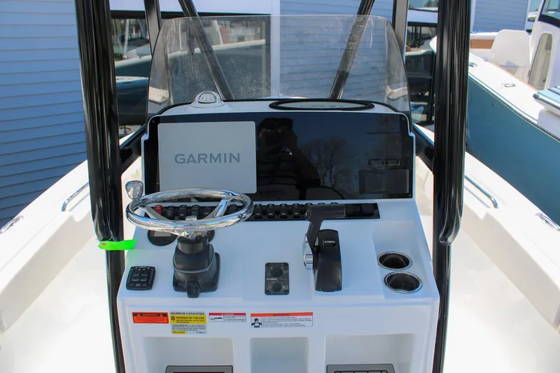 Slide: The Image of 2026 Sea Hunt Ultra 219 boat console with Garmin navigation system and steering wheel. - 2