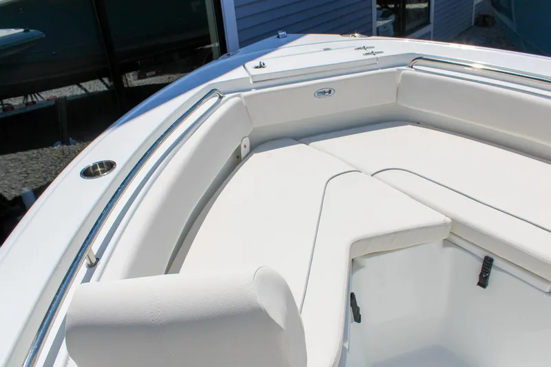 Slide: The Image of 2026 Sea Hunt Ultra 219 boat interior with white cushioned seating and stainless steel railings. - 23