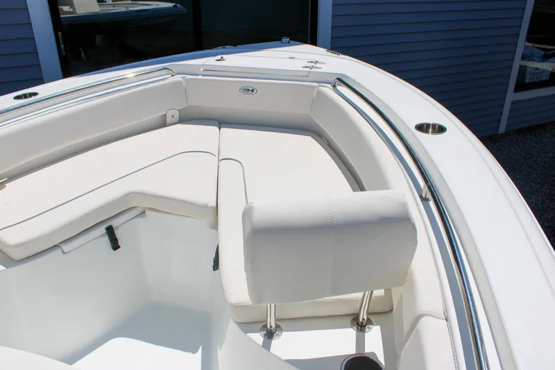 Slide: The Image of 2026 Sea Hunt Ultra 219 boat interior with white cushioned seating and stainless steel railings. - 24