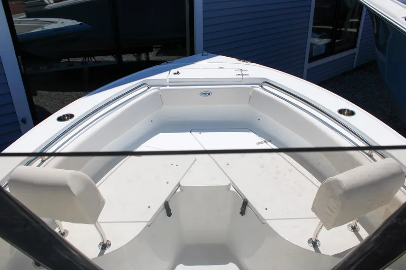 Slide: The Image of 2026 Sea Hunt Ultra 219 boat interior with white seating and stainless steel railings. - 25