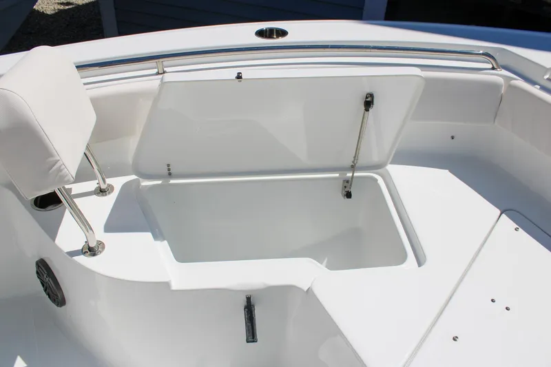 Slide: The Image of 2026 Sea Hunt Ultra 219 boat storage compartment with open hatch and seating. - 26