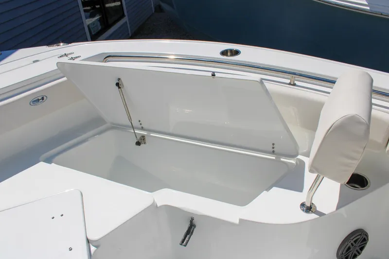 Slide: The Image of 2026 Sea Hunt Ultra 219 boat with open storage compartment and cushioned seating. - 27