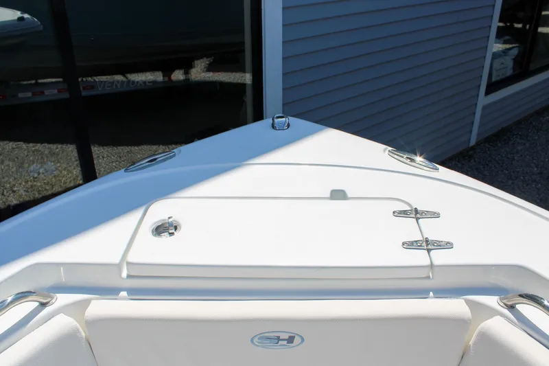 Slide: The Image of Bow view of 2026 Sea Hunt Ultra 219 boat, showcasing sleek design and storage hatch. - 28