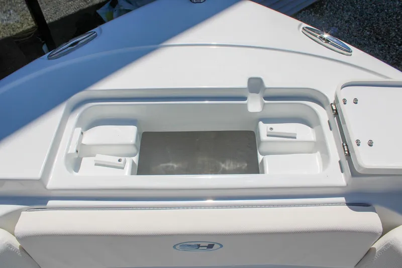 Slide: The Image of 2026 Sea Hunt Ultra 219 boat deck with storage compartment and sleek design. - 29