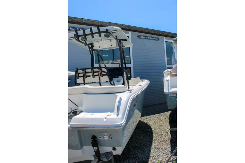 Slide: The Image of 2026 Sea Hunt Ultra 219 boat displayed outdoors near a showroom. - 6